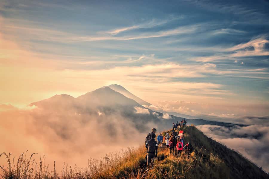 Trekkers on the crater rim of Mount Batur as the sun comes up